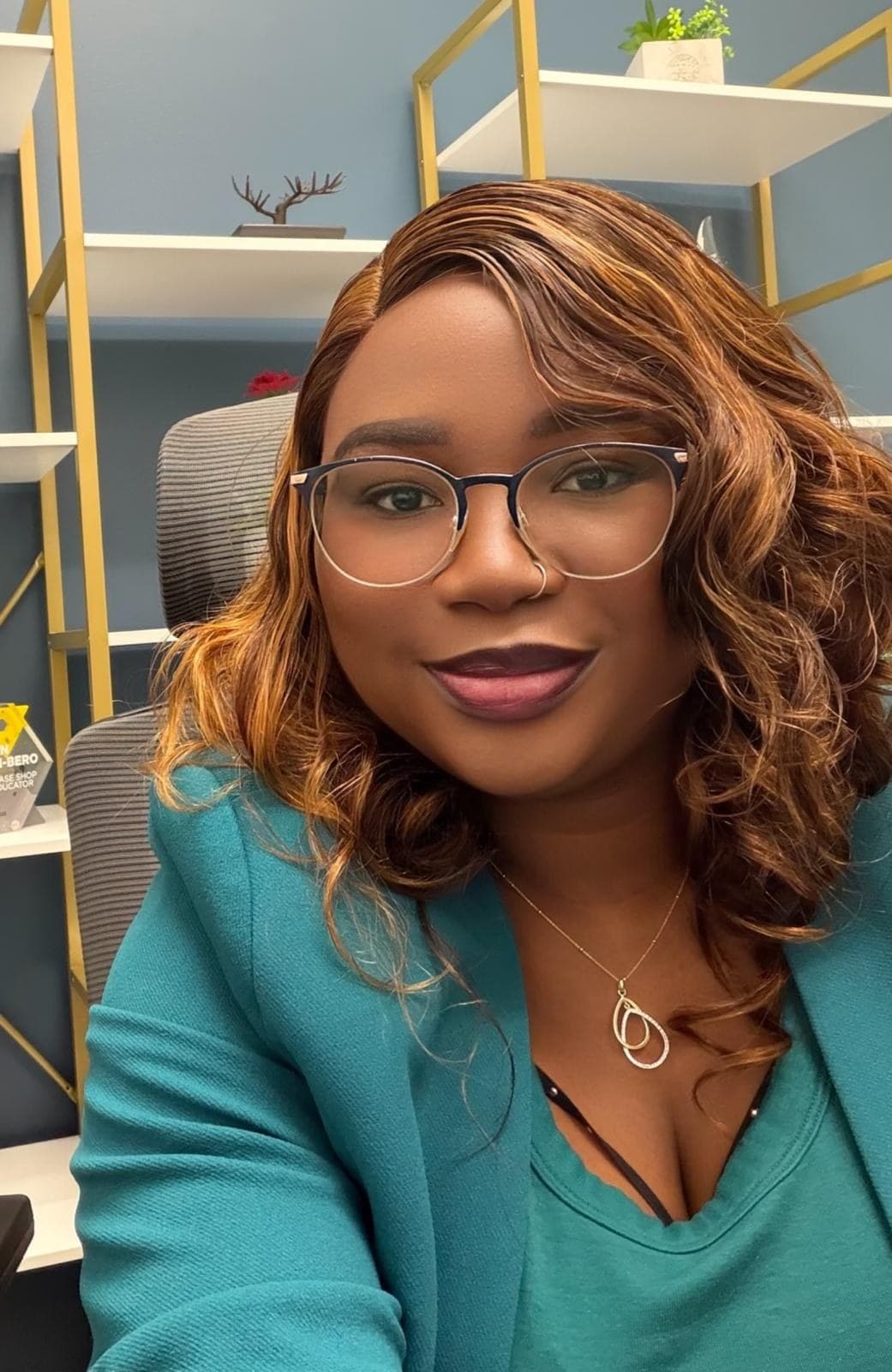 Hydee smiling in her office